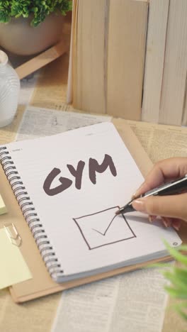 VERTICAL-VIDEO-OF-TICKING-OFF-GYM-WORK-FROM-CHECKLIST