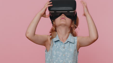 Child-girl-kid-using-virtual-reality-VR-app-headset-to-play-simulation-3D-video-game-watching-video