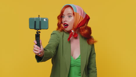 Girl-blogger-take-selfie-on-mobile-phone-selfie-stick-communicate-video-call-online-with-subscribers