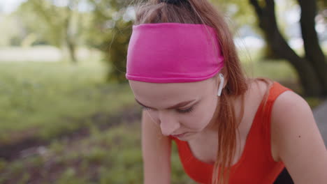 Athletic-fitness-sport-motivated-runner-girl-training,-preparing-to-run-race-marathon,-start-in-park