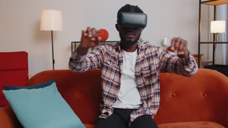 Young-man-use-virtual-reality-headset-glasses-at-home,-enjoying-video-concept-moving-hands-in-air