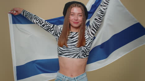 Mujer-Joven-En-Top-Corto-Ondeando-Y-Envolviendo-La-Bandera-Nacional-De-Israel,-Celebrando-El-Día-De-La-Independencia