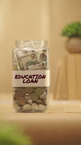 VERTICAL-VIDEO-OF-PERSON-SAVING-MONEY-FOR-EDUCATION-LOAN