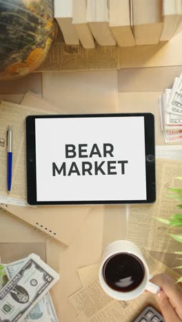 VERTICAL-VIDEO-OF-BEAR-MARKET-DISPLAYING-ON-FINANCE-TABLET-SCREEN