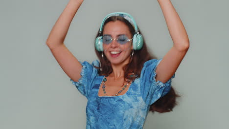 Happy-young-woman-in-blue-princess-dress-listening-music-and-dancing-disco-fooling-around-having-fun