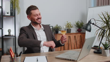 Businessman-make-video-call-conversation-on-laptop-celebrate-successful-contract-drinking-champagne