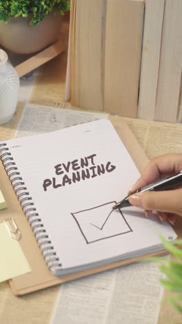VERTICAL-VIDEO-OF-TICKING-OFF-EVENT-PLANNING-WORK-FROM-CHECKLIST