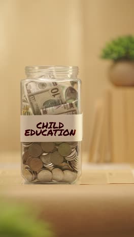 VERTICAL-VIDEO-OF-PERSON-SAVING-MONEY-FOR-CHILD-EDUCATION