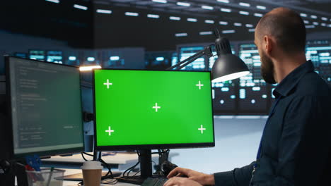 System-administrator-working-on-green-screen-computers-in-data-center