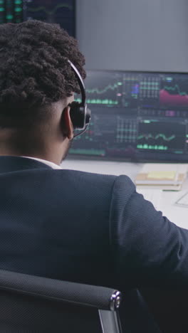 Multi-ethnic-team-of-traders-work-on-multi-monitor-computers-with-displayed-real-time-stocks.-Colleagues-analyze-exchange-market-charts-on-big-screens.-Cryptocurrency-trading-and-investment-concept.