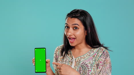 Woman-presenting-green-screen-mobile-phone