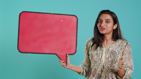 Woman-holding-red-speech-bubble-sign-of-empty-copy-space-for-message