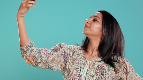 Cheerful-woman-using-smartphone-to-take-selfies