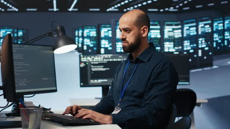 Engineer-coding,-working-in-data-center-facility-hosting-supercomputers