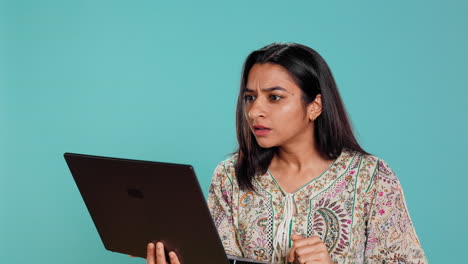 Irked-woman-fighting-with-coworkers-during-videocall-on-laptop