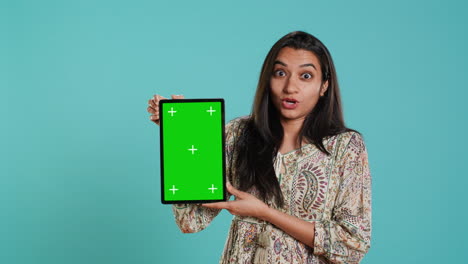 Portrait-of-woman-doing-influencer-marketing-using-green-screen-tablet