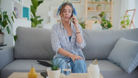Lonely-Woman-Expressing-Sadness-During-Phone-Call-at-Home