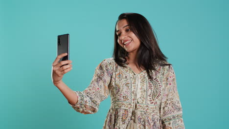 Joyous-girl-taking-pictures-using-phone-selfie-camera