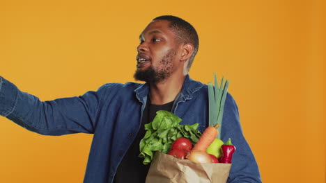 African-american-man-recommending-ethically-sourced-food-from-farmers-market
