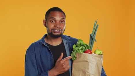 African-american-person-pointing-at-ethically-sourced-fruits-and-veggies