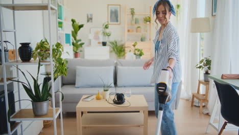 Joyful-Woman-Cleaning-House-with-Vacuum