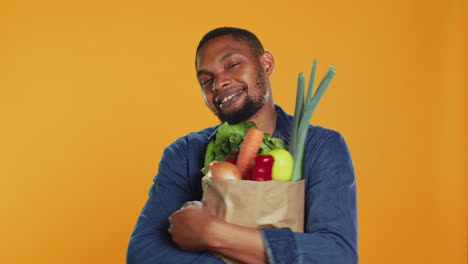 Male-model-hugging-his-paper-bag-full-of-organic-homegrown-food