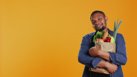 Male-model-hugging-his-paper-bag-full-of-organic-homegrown-food