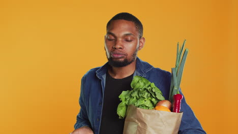 African-american-vegan-guy-taking-a-bite-from-a-ripe-natural-green-apple