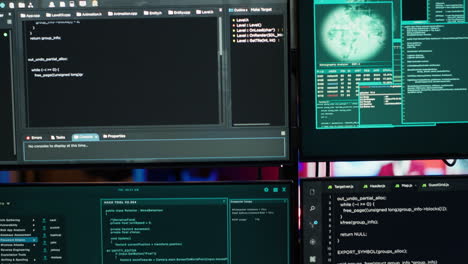 Close-up-of-code-running-on-computer-displays-in-empty-apartment-used-by-hacker