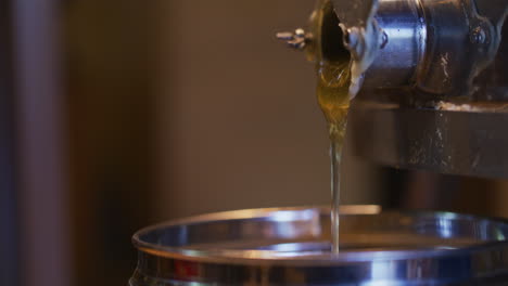 Honey-Pouring-from-Centrifuge-into-Jar