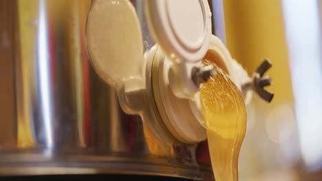 Golden-Thick-Honey-Pouring-from-Production-Tank