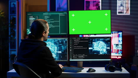 Hacker-using-green-screen-monitor-and-AI-to-write-spyware