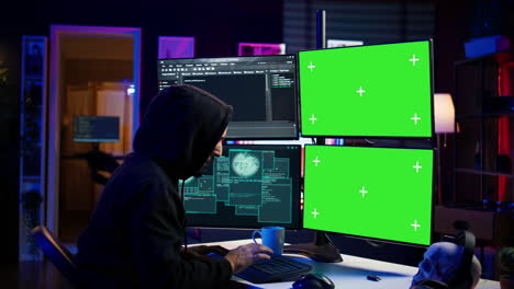 Hacker-developing-spyware-software-on-green-screen-computer-to-steal-data