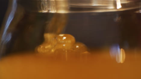 Pouring-Honey-into-Jar-in-Family-Apiary
