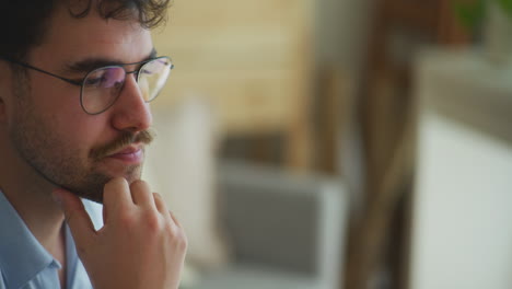 Pensive-Man-with-Glasses-Thinks-for-Inspiration