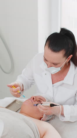 Cosmetologist-doing-peeling-procedure,-woman-skin-regeneration,-dermapen-microneedling,-dermastamp