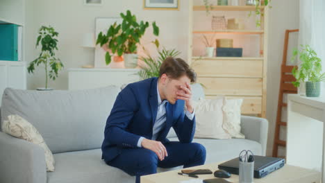 Sad-Depressed-Businessman-on-Sofa