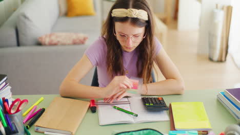 Happy-Young-Smart-Student-Doing-Math-Homework-and-Writing-in-a-Notebook