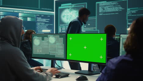 Governmental-hackers-working-on-computer-with-green-screen