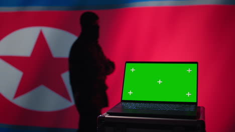North-Korea-army-soldier-using-military-tech-on-green-screen-laptop