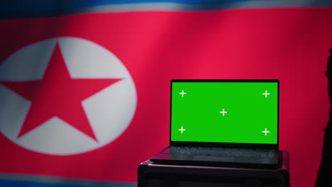 Pyongyang-regime-army-soldier-scanning-rockets-with-chroma-key-notebook