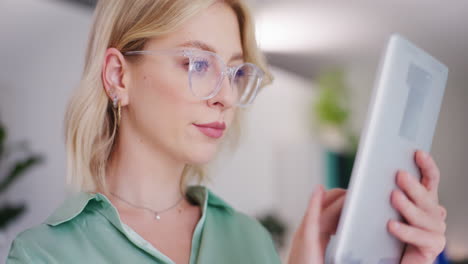 Woman-with-Glasses-Using-Digital-Tablet-in-Office