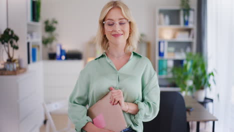 Confident-Woman-Holding-Laptop-in-Office