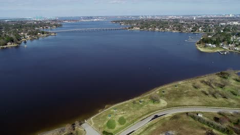 Flying-over-a-park-in-Portsmouth-Virginia-showing-the-Elizabeth-River-and-the-Churchland-bridge