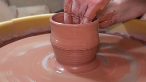 Shaping-up-a-the-walls-of-a-pottery-cup-on-the-wheel