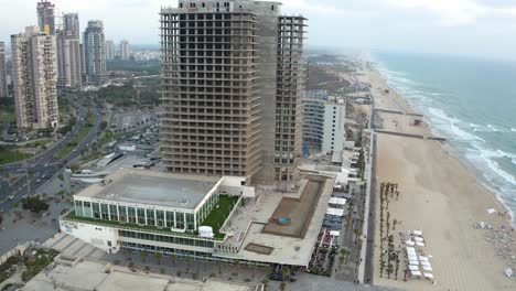 Drone-shot-of-a-high-building-by-the-shore