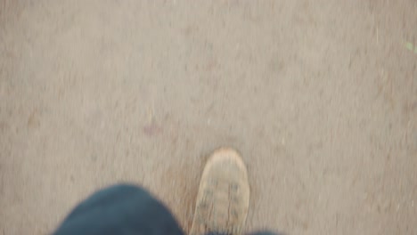 FPV-downward-view-of-person-walking-with-sneakers-and-jeans