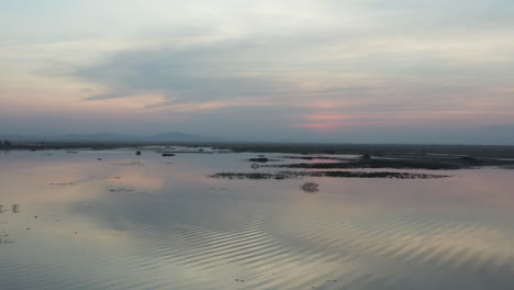 Slow-aerial-pan-over-Kamping-Puoy-reservoir-at-sunset
