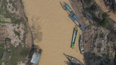 Birds-eye-view-over-muddy-river-im-Cambodia-with-boat-traffic-on-Tonle-Sap