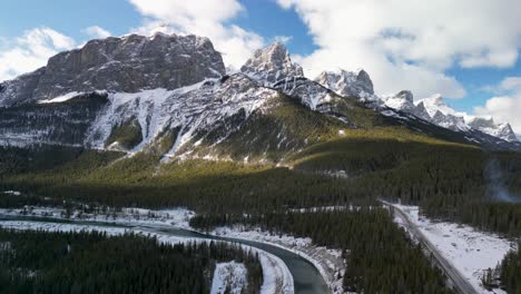 Aerial-view-of-Bow-River-and-mountains,-Canmore,-Alberta,-Canada---Drone-4k